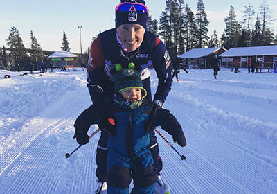 Kikkan skiing with son, Breck.